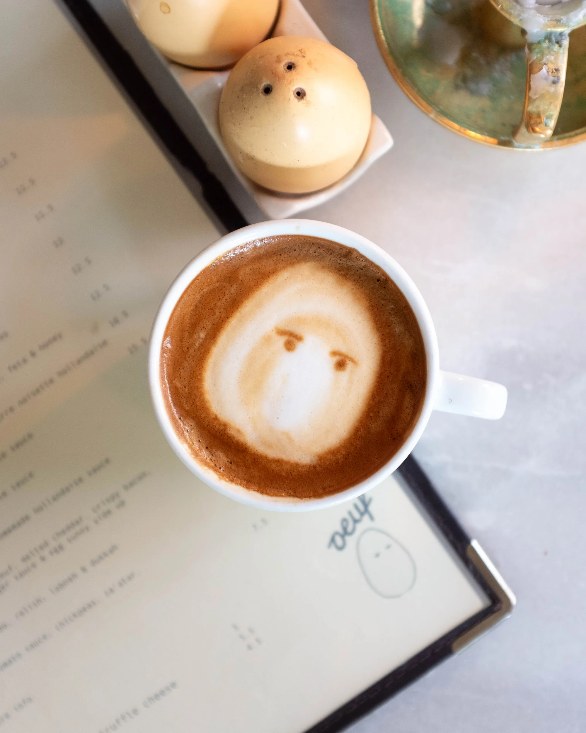 Specialty coffee being served at Oeuf Amsterdam brunch cafe